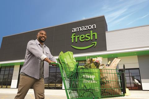 A shopper stands in front of the Amazon Fresh store